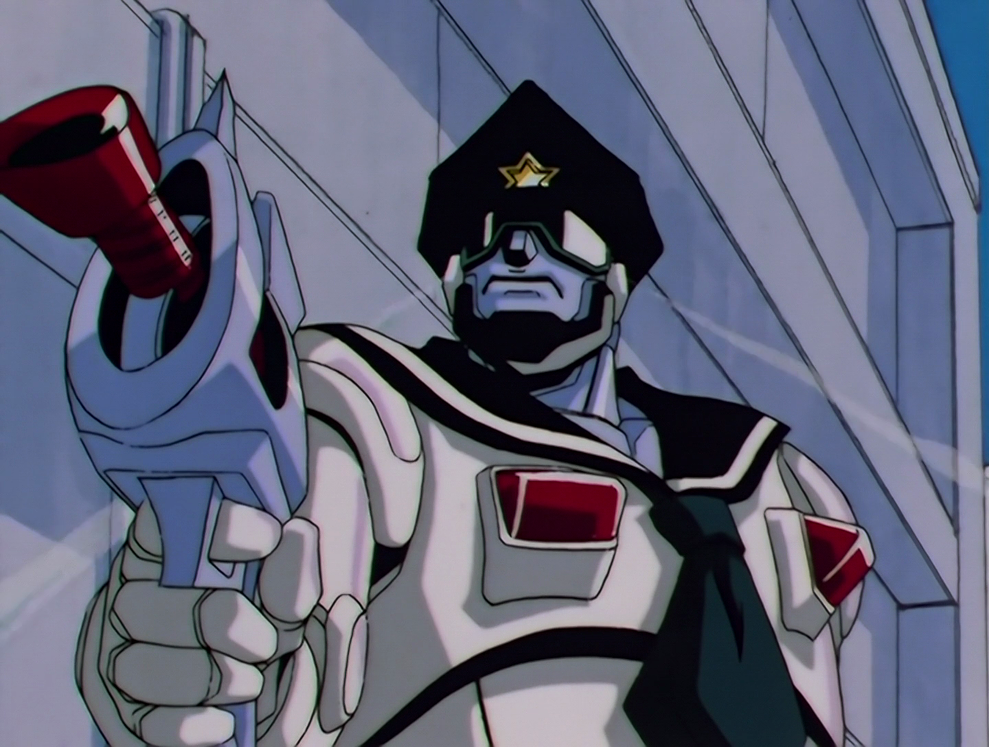Sailor Cop, a Phage from Sailor Moon episode 182. He resembles a robotic American cop with a sailor collar. Naturally he’s pointing a gun at someone.